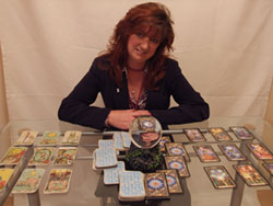 Susan Seraphim offering a tarot reading with candles and cards